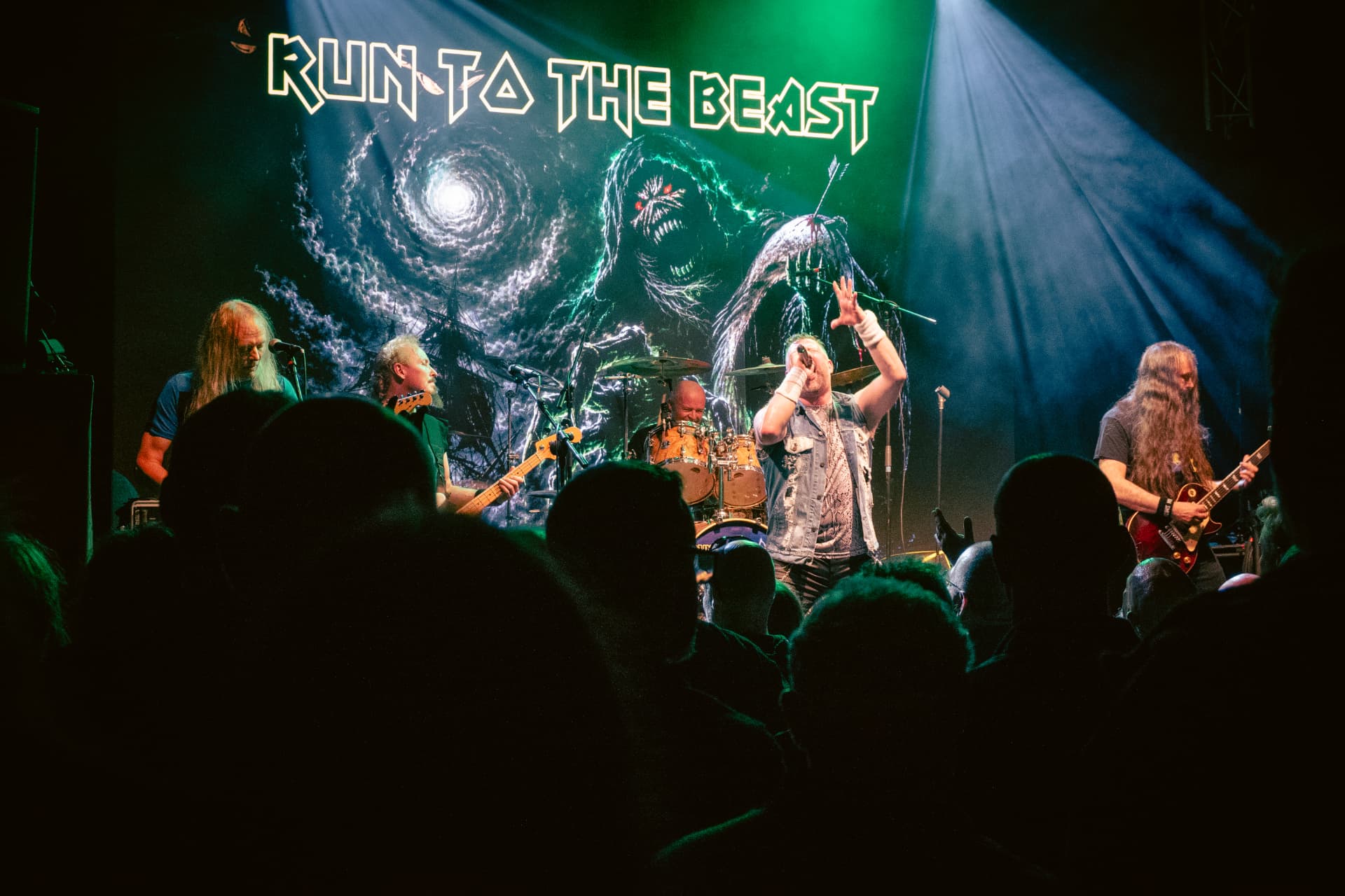 Run to the Beast performing at The Button Factory, Dublin — the band mid-set with the crowd in silhouette