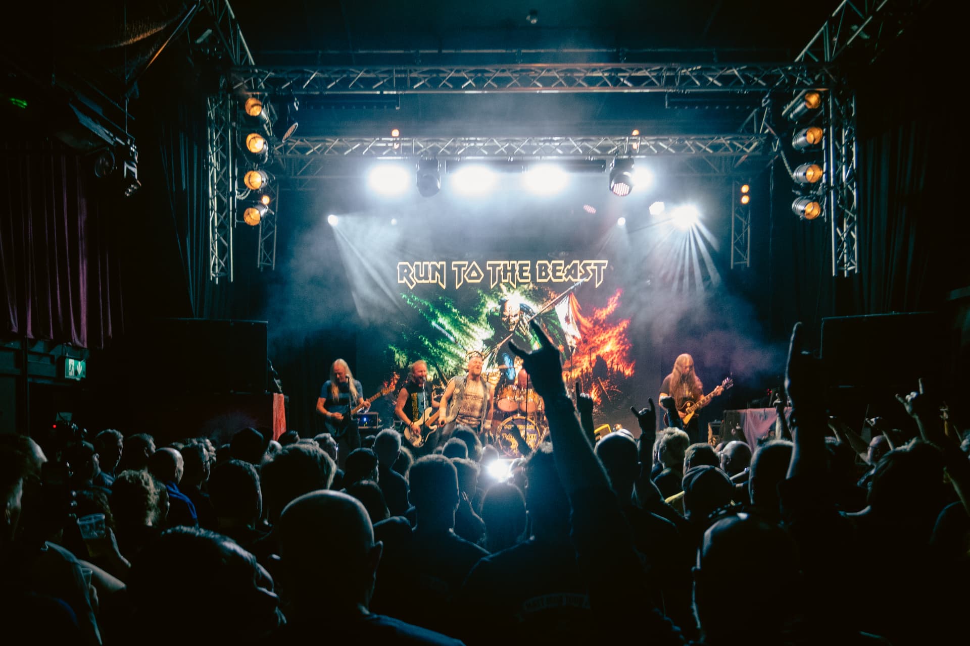 Run to the Beast performing at The Button Factory, Dublin — wide view of the packed room and full lighting rig